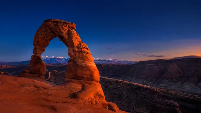 Arco del Delirio con montañas nevadas al atardecer