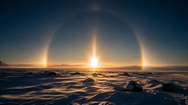 Sol y arcoíris en un paisaje ártico nevado